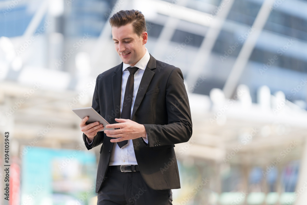 Portrait of smiling businessman using at tablet Portrait of smiling businessman using at tablet