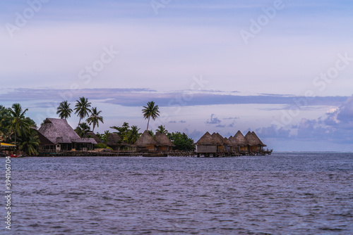 bungalow resort in tropical island in the ocean in raiatea bora bora french polynesia sunset photo