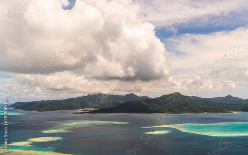 tropical island in the ocean with reef lagoon in tahaa island in french polynesia  photo