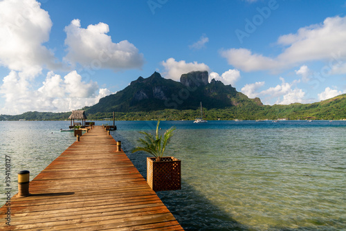 wooden pier on ocean with reef lagoon and mountains in bora bora french polynesia island © Blogtrip