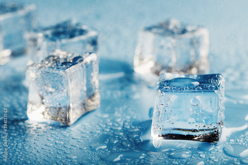 Blocks of Ice With water Drops close-up. Macro ice refreshing cube for a drink on a hot day Blocks of Ice With water Drops close-up. Macro ice refreshing cube for a drink on a hot day