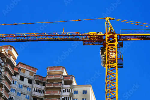 Construction site background. Big tower crane near building. Industrial background.