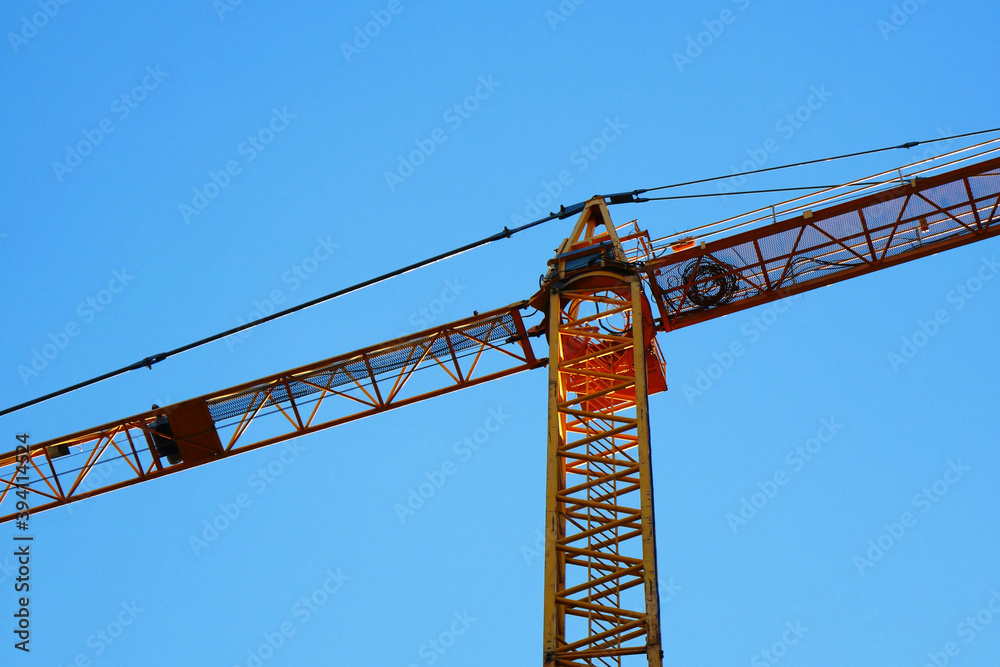 Crane. Big tower crane against blue sky. Construction crane.