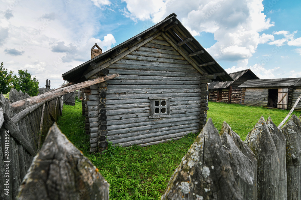 Close up of historic wooden farmstead surrounded by palisade Close up of historic wooden farmstead surrounded by palisade