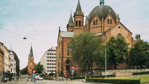 Oslo, Norway. Traffic Near Trefoldighetskirken - Holy Trinity Church at Akersgata Street. Summer Day. 4K photo