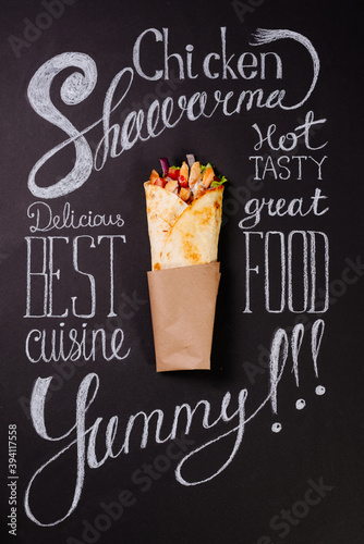chicken shawarma on black chalkboard around chalk lettering