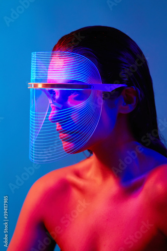 Woman using Led Mask - Blue & Red Antibacterial light photo