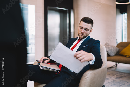 Successful businessman doing paperwork in office