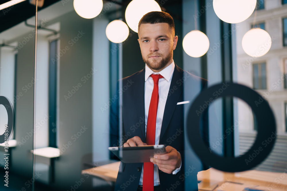 Serious businessman with tablet in office Serious businessman with tablet in office