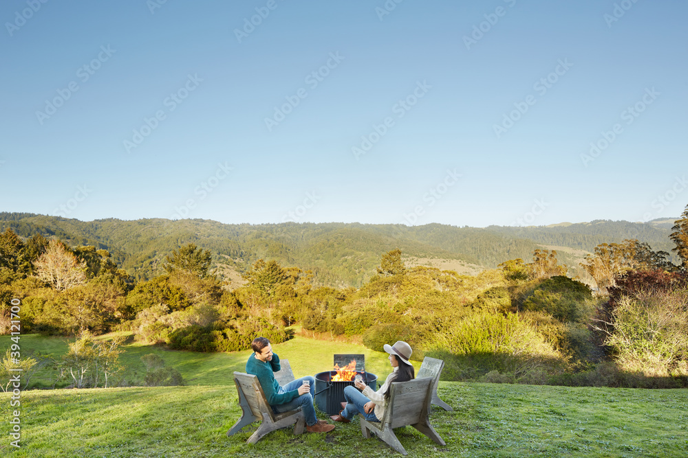Couple sitting at outdoor fire pit Couple sitting at outdoor fire pit