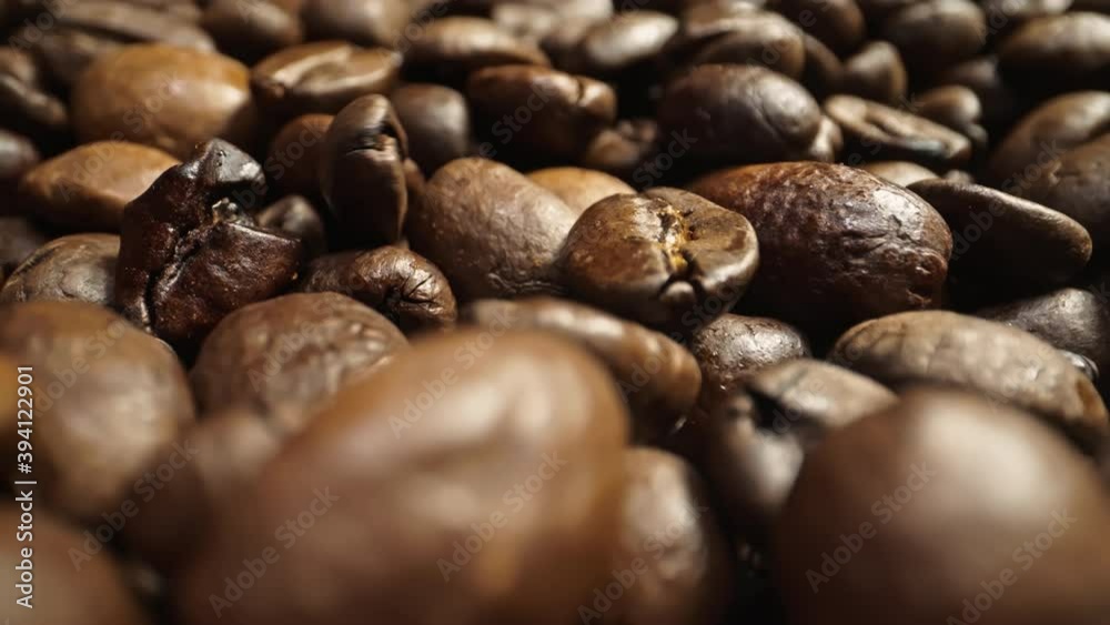 Close up of rolling roasted coffeebeans shot in 4k Close up of rolling roasted coffeebeans shot in 4k