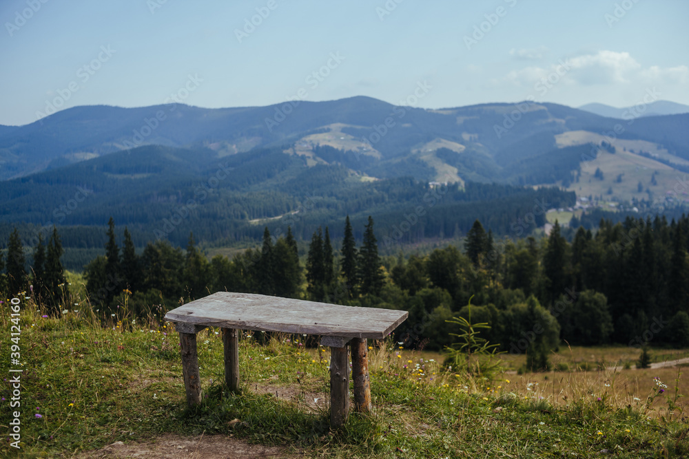 Empty bench with view over the mountains. old chair and blue sky view background