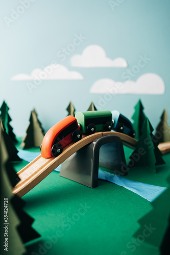 Wooden Train Toy Crossing The Bridge In The Forest Made Of Paper photo