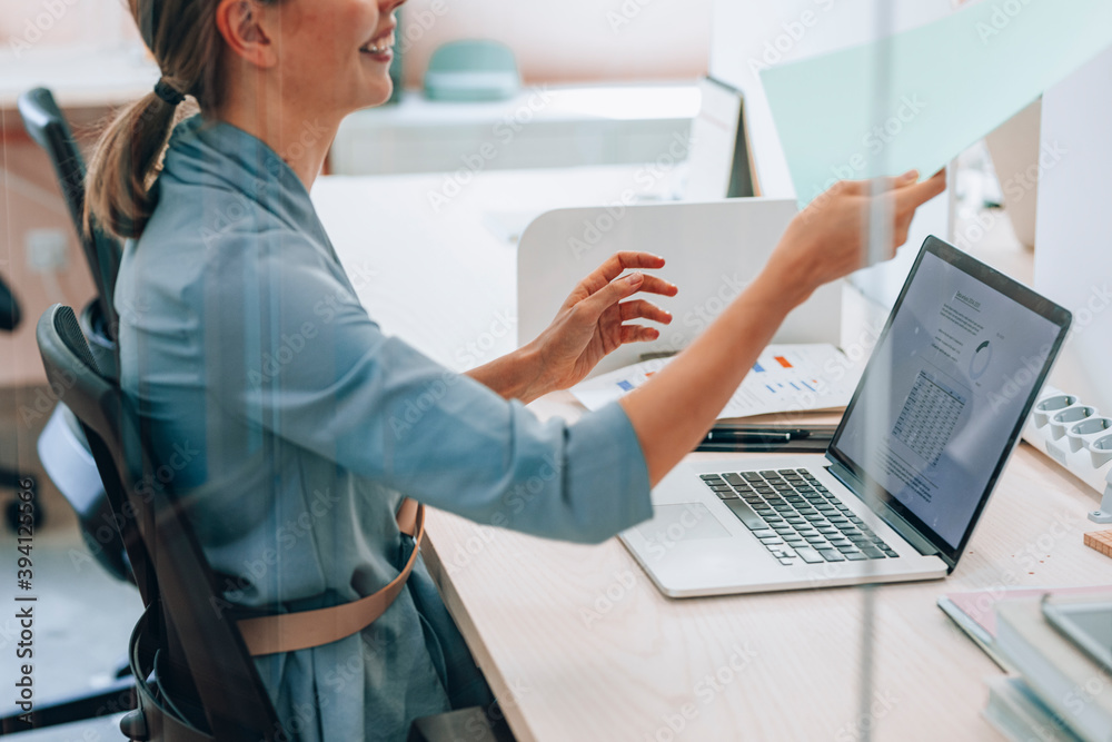 © Lumina/Stocksy - Smiling Businesswoman Working at Office © Lumina/Stocksy - Smiling Businesswoman Working at Office