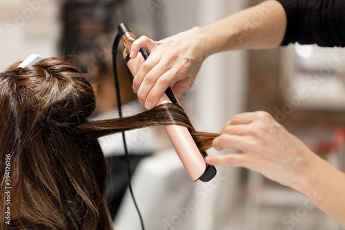 Young woman using the services of a hairstyle saloon. photo
