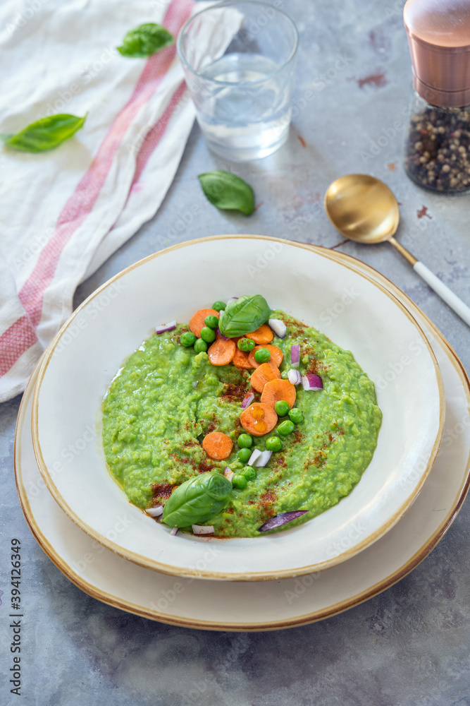 Green Peas creamy soup topped with carrots and herbs. Green Peas creamy soup topped with carrots and herbs.