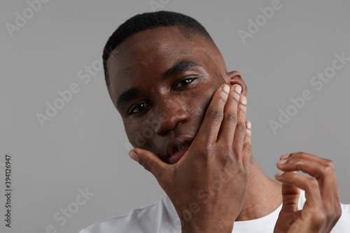 Man using after shave lotion photo
