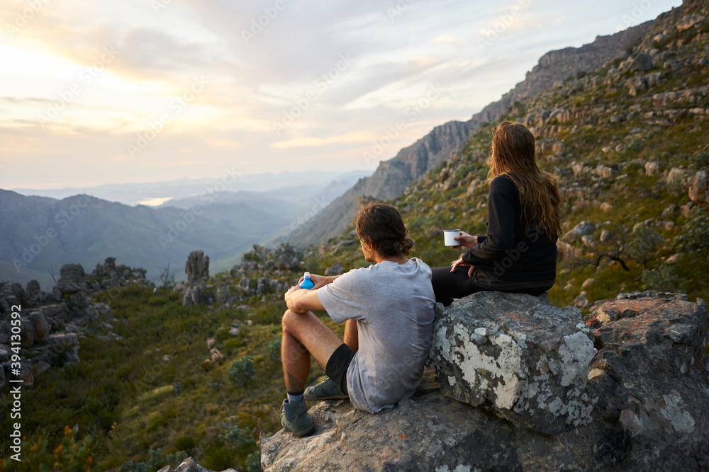 Hiking couple watching the sunset Hiking couple watching the sunset