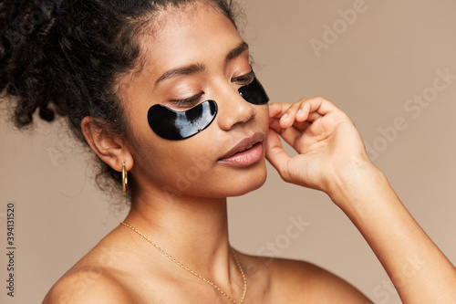 Beautiful woman under eye beauty treatment