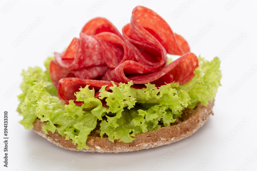 Sandwich with salami sausage on white background. Sandwich with salami sausage on white background.