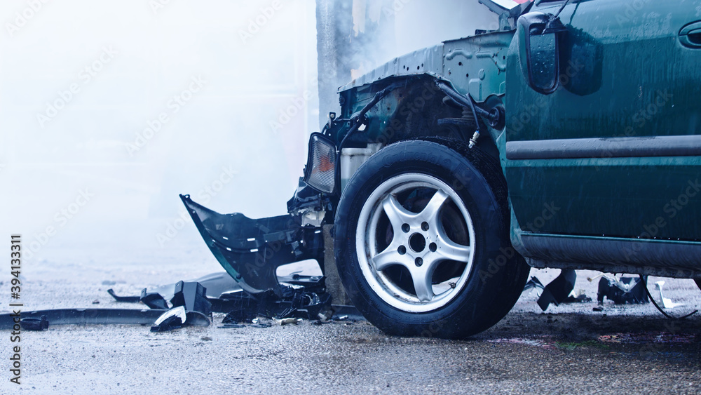 Fototapeta Smoke from wrecked car with fire engine in the background. Car accident. High quality photo