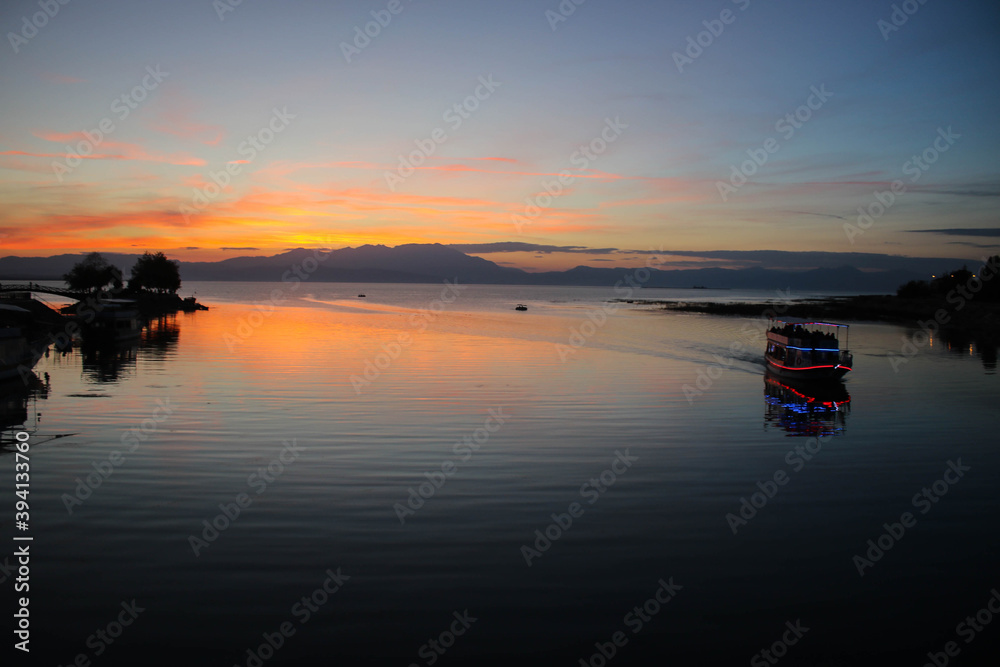 Sunset view on the lake with a yatch Sunset view on the lake with a yatch