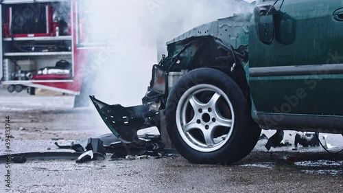 Smoke from wrecked car with fire engine in the background. Car accident. High quality 4k footage