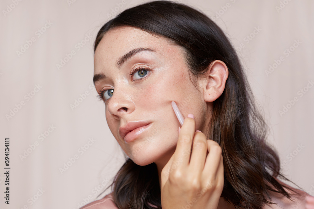 Girl using gua sha stone