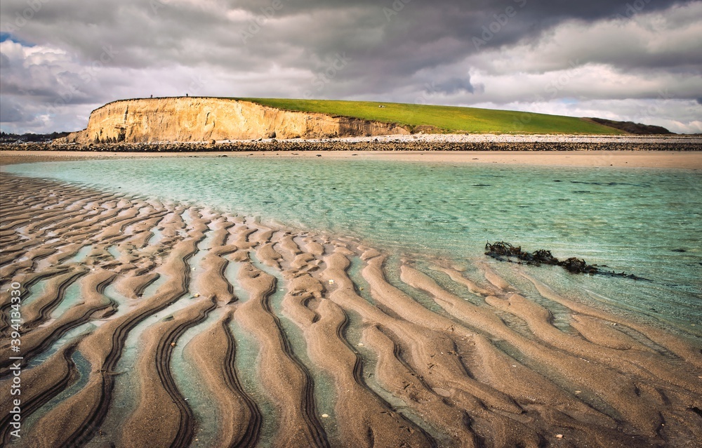 Beautiful scenery of sand, water an mountain at Silverstrand beach in Galway, Ireland