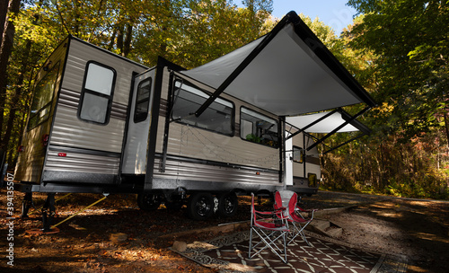 Travel trailer set up for camping at in the trees at Falls Lake NC with awnings extended © Guy Sagi