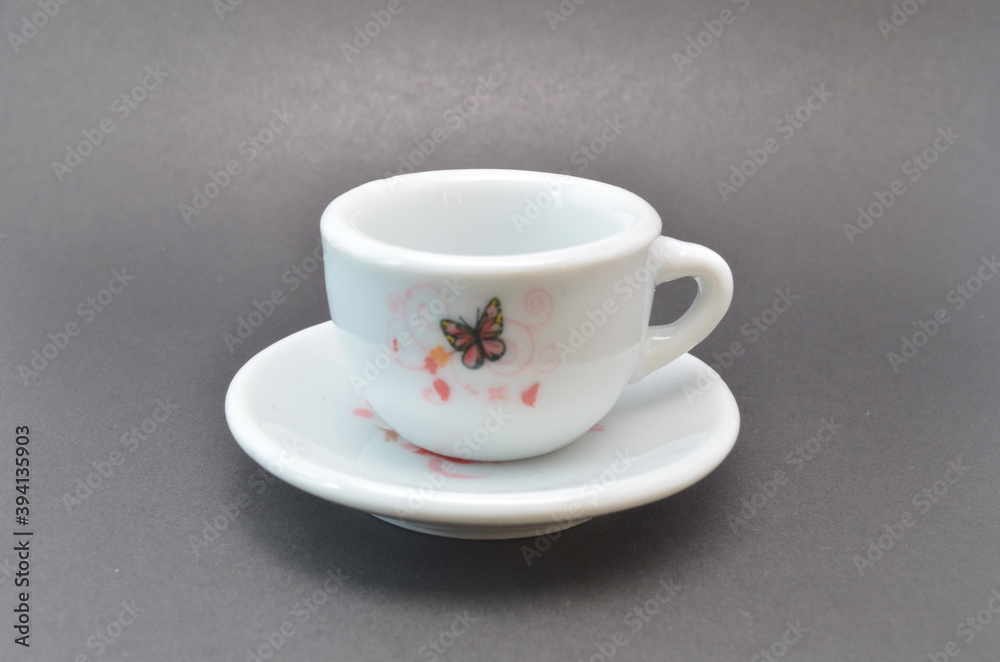Fototapeta premium White mug with drawings on a dark background