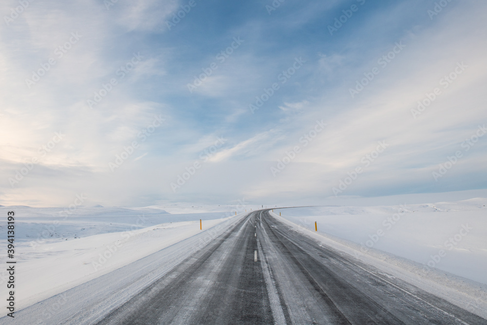 Empty winter road among snowdrifts. Winter landscape in Iceland