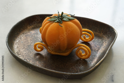 Pumpkin carriage dessert in a fairytale themed fine dessert cafe in Bangkok, Thailand photo