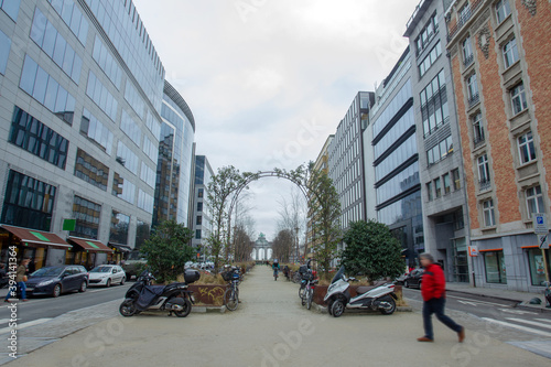 Street in Brussels with blurred from motion persons and greenery