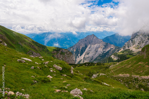 summer mountains green grass and blue sky landscape near achensee in austria, europe alps in cloudy day