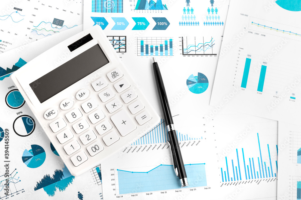 Calculator, pen and charts, documents and graphs. Calculator, pen and charts, documents and graphs.