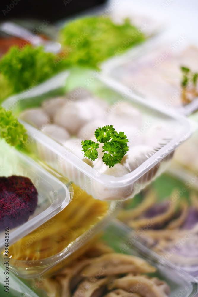 A variety of prepackaged food products in plastic boxes