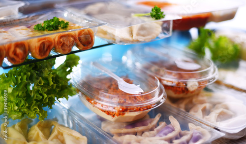 Valokuva A variety of prepackaged food products in plastic boxes