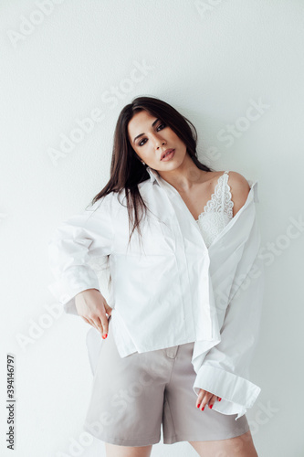 Portrait of a beautiful fashionable oriental brunette woman in a white shirt
