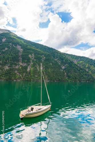 Lonely boat on Lake Achensee or Lake the water surface. At the background are the Alps in Innsbruck, Austria