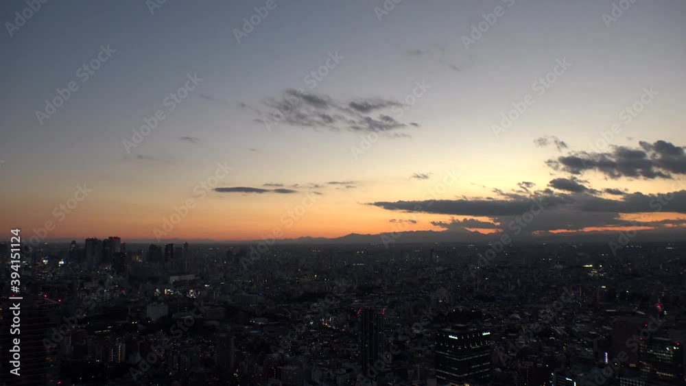 TOKYO, JAPAN : Aerial high angle sunrise CITYSCAPE of TOKYO. View of buildings around Shinjuku and Nakano ward. Japanese urban metropolis and nature concept. Time lapse zoom out shot night to morning. TOKYO, JAPAN : Aerial high angle sunrise CITYSCAPE of TOKYO. View of buildings around Shinjuku and Nakano ward. Japanese urban metropolis and nature concept. Time lapse zoom out shot night to morning.