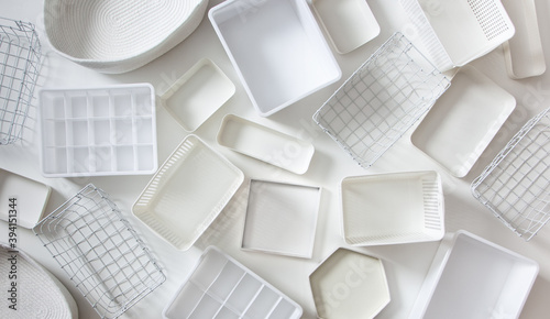 Flat lay of Marie Kondo's white storage boxes, containers and baskets with different sizes and shapes photo