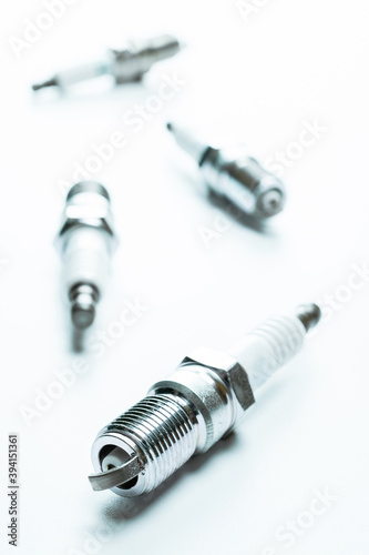 Car engine. Set of new metal car part. Auto spark plugs or automotive piece isolated on white background. Automobile engine service.