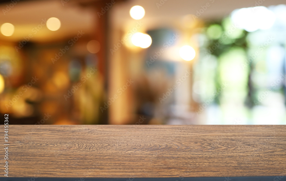 Empty wooden table in front of abstract blurred background of coffee shop . can be used for display or montage your products.Mock up for display of product Empty wooden table in front of abstract blurred background of coffee shop . can be used for display or montage your products.Mock up for display of product