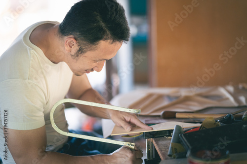 craft man making guitar on wood table, capenter working concept photo