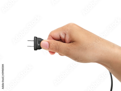 close-up of male hand holding electric plug