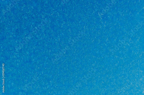blue frost on a glass background. texture patterned frosted glass.