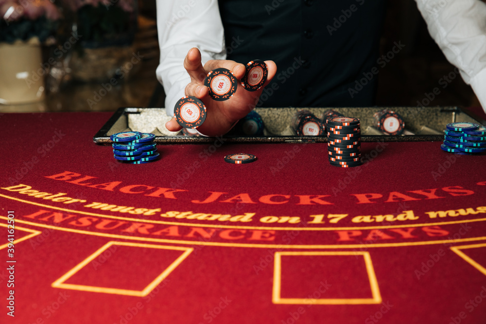 Croupier hands dealing cards on t blackjack poker table, gambling table with cards and chips - obrazy, fototapety, plakaty 