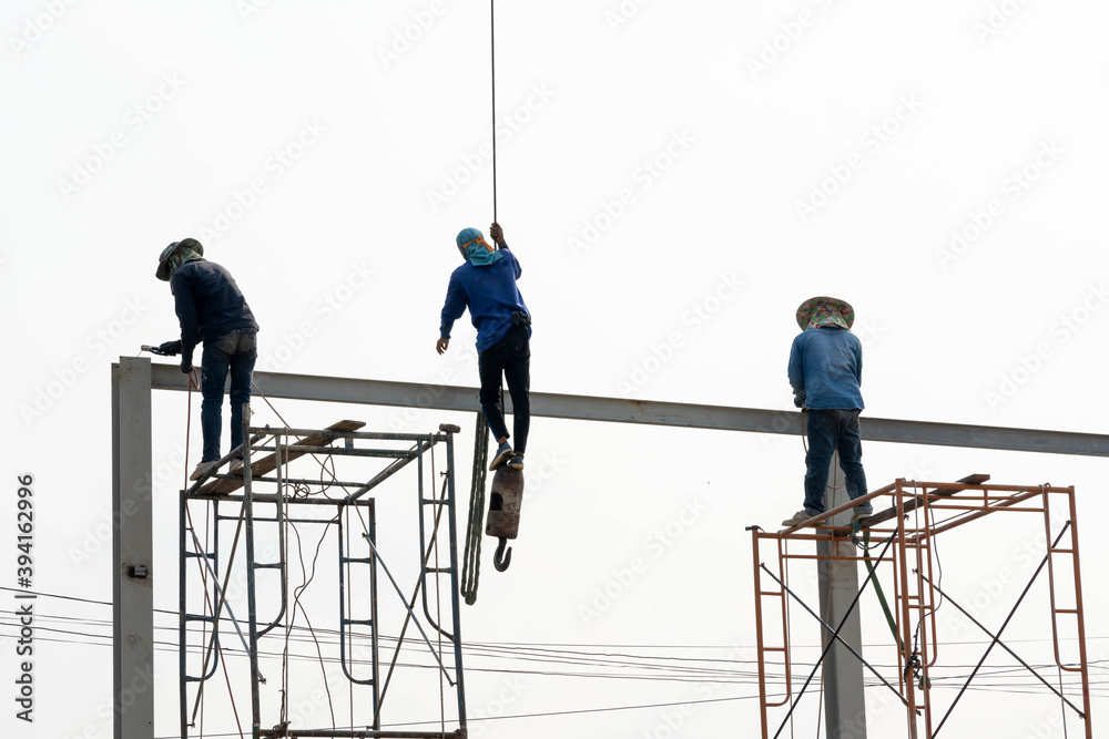 Fototapeta premium Construction Scaffolding Worker conect the steel beam by gas welding equipment