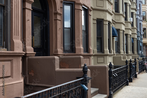 Row of Beautiful Old Brick Brownstone Homes in Hoboken New Jersey along a Sidewalk